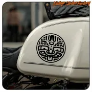 Black circular design with stylised face applied to a motorbike fuel tank