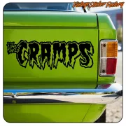 Black “THE CRAMPS” adhesive applied to the rear of a green vehicle
