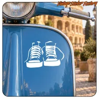 Zwei weiße Turnschuhe auf der blauen Vorderseite eines Rollers