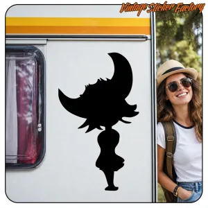 Silhouette of a girl wearing a witch hat applied to a caravan next to a female traveller