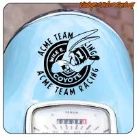 Circular ACME TEAM RACING design on a motorcycle body, beside the speedometer