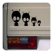 Several black alien silhouettes in different sizes applied to the rear of a vehicle