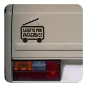 «ABIERTO POR VACACIONES» sticker beside the rear light of a motorhome