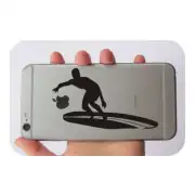 Black surfer on longboard sticker applied to the back of a phone