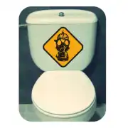 Masque à gaz dans un losange jaune appliqué sur le réservoir d’un WC