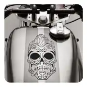 Ornamental black and white skull placed on the fuel tank of a motorcycle