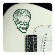 Calavera adhesiva verde aplicada junto a la pastilla de una guitarra eléctrica
