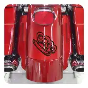 Black adhesive American fist applied to the red rear of a motorcycle