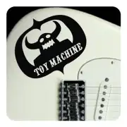 Adhesivo TOY MACHINE colocado en la parte superior de una guitarra eléctrica