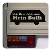 Black «Mein Haus - Mein Auto Mein Bulli» sticker placed on the rear of a van