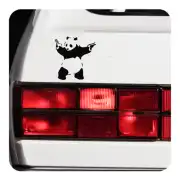 Urban-style panda placed on the white rear of a vehicle