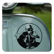 Circular adhesive applied to the side of a scooter-style motorcycle