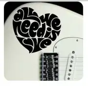 «ALL WE NEED IS LOVE» slogan applied to an electric guitar