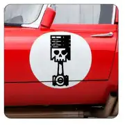 Piston sticker with skull applied to the door of a red car